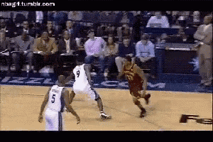 a basketball game is being played in front of a crowd and a player with the number 9 on his jersey