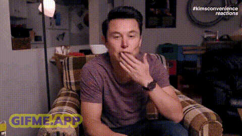 a man is sitting in a chair covering his mouth with his hand and a gifme app icon is visible