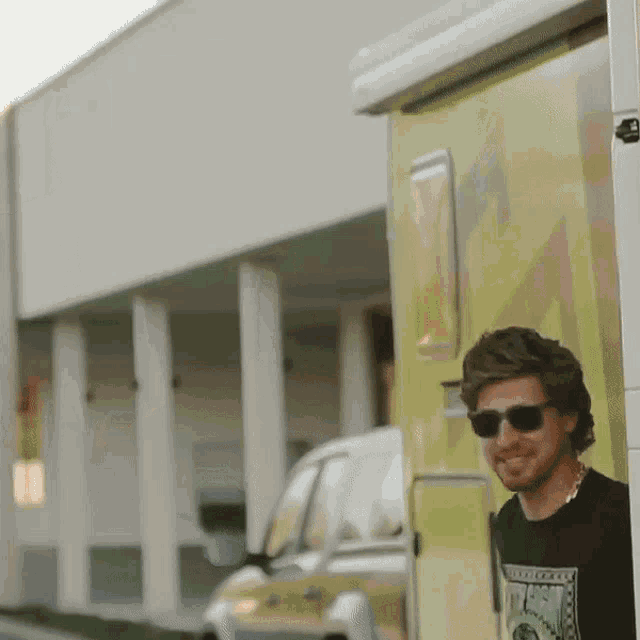 a man wearing sunglasses and a t-shirt that says ' abercrombie & fitch ' on it