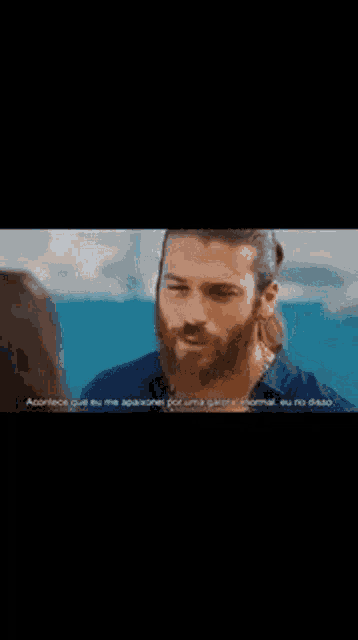 a man with a beard is talking to a woman on a boat