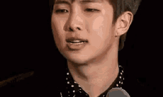 a close up of a man 's face with his eyes closed and his mouth open .