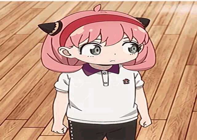 a little girl with pink hair is laying on a wood floor