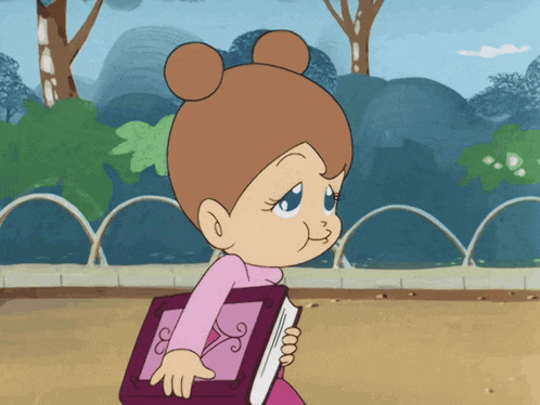 a girl in a pink shirt is holding a book with the letter e on it