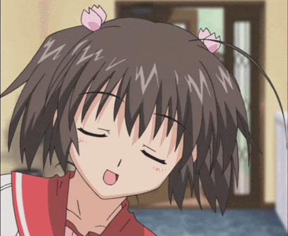 a close up of a girl 's face with a pink flower in her hair