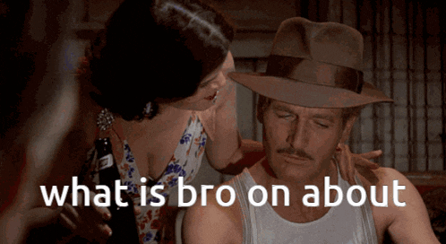 a man in a fedora is being comforted by a woman who is holding a bottle of beer