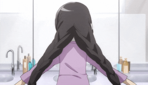 a girl in a purple shirt is looking at her hair in front of a mirror