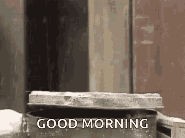 a person is standing in front of a trash can with the words `` good morning '' .