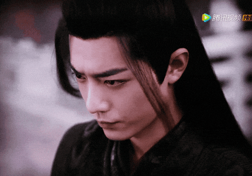 a close up of a man 's face with a chinese advertisement in the background