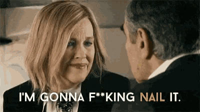 a woman in a suit is talking to a man in a suit .