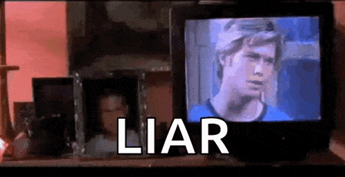 a tv with a picture of a man on it and the word liar written on it .