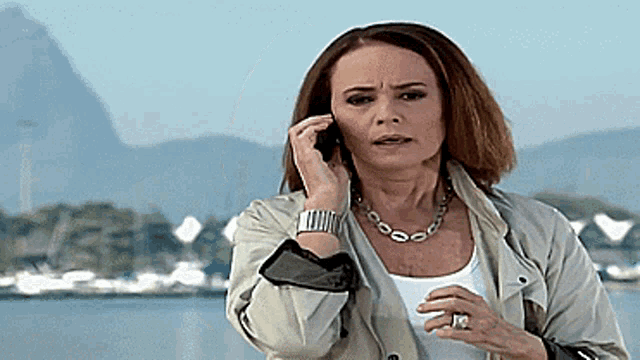 a woman with a ring on her finger is talking on her cell phone