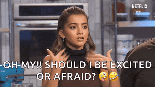 a woman is talking to a man in a kitchen and says `` oh my should i be excited or afraid '' .