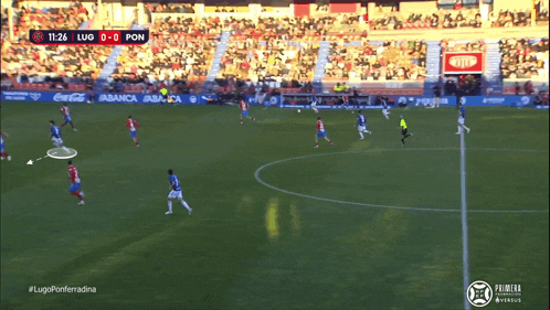 a soccer game is being played in a stadium sponsored by coca cola