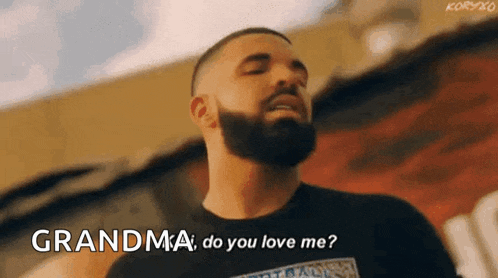 a man with a beard is standing in front of a building and talking to his grandma .