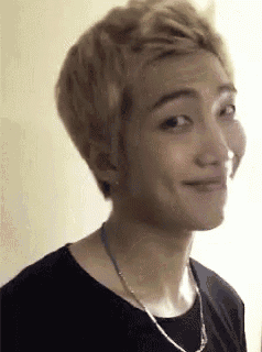 a close up of a young man making a funny face .