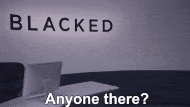 a computer sits in front of a wall that says blacked