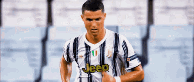 a soccer player wearing a jeep jersey runs on the field