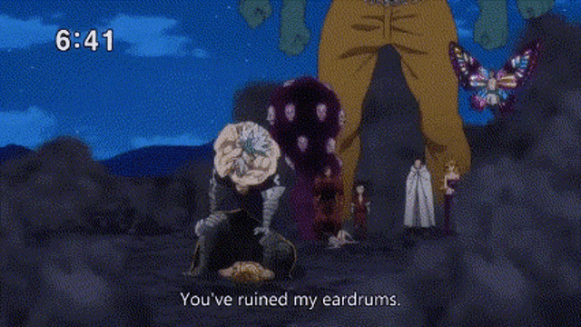 a group of cartoon characters are standing next to each other on a rocky hillside .