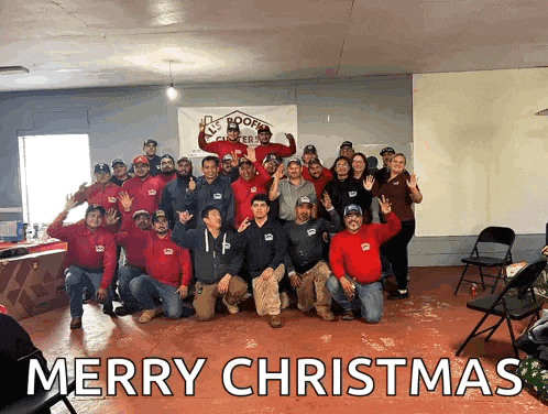 a group of people posing for a picture with the words merry christmas written above them