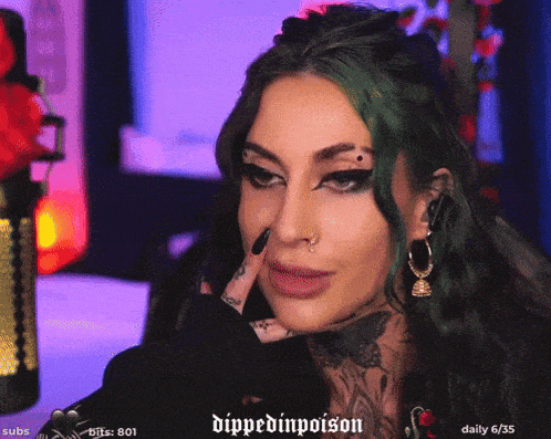 a woman with green hair is sitting in front of a microphone with the words dipped in poison written on the bottom