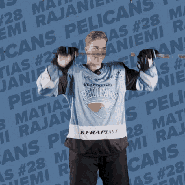 a pelican 's hockey player holds a hockey stick in his mouth