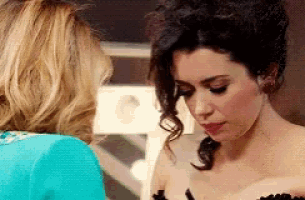 a woman in a blue jacket is talking to another woman