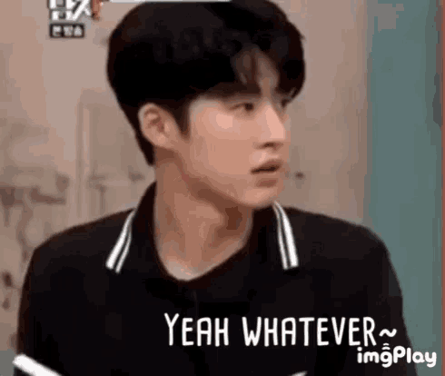 a young man in a black shirt is making a funny face and saying `` yeah whatever '' .