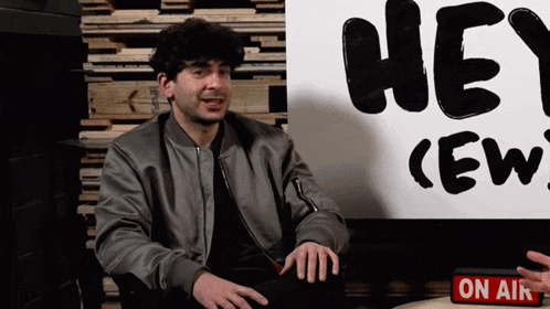 a man in front of a sign that says hey crew