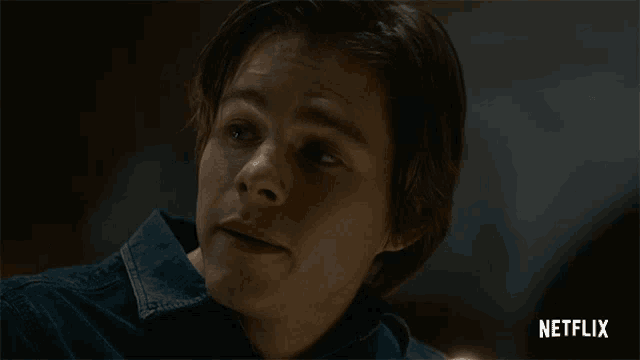 a close up of a man 's face with a netflix logo in the background