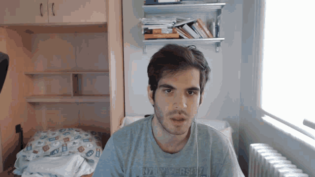 a man wearing a grey shirt that says abercrombie & fitch on it