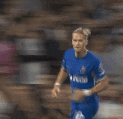 a blurry picture of a soccer player kneeling down
