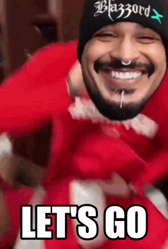 a man with a beard wearing a black beanie that says blazord on it