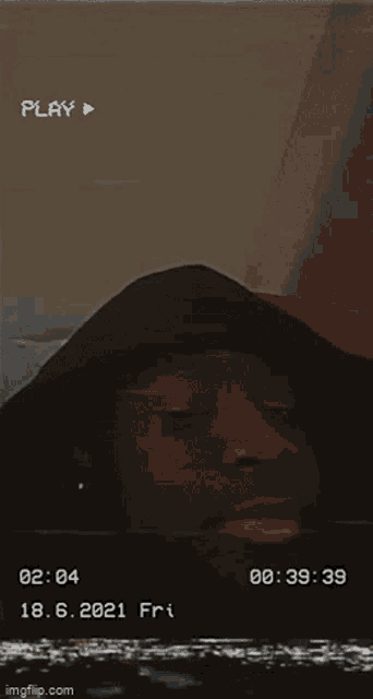 a man in a black hoodie is on a video tape that says play at the top