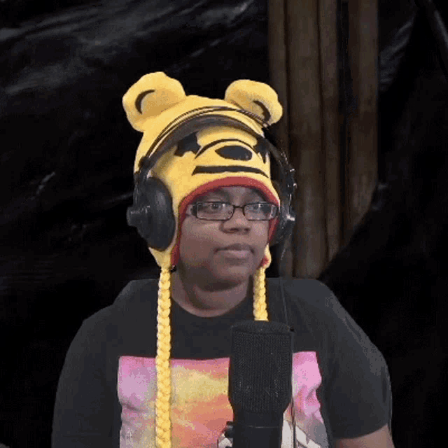 a man wearing headphones and a winnie the pooh hat