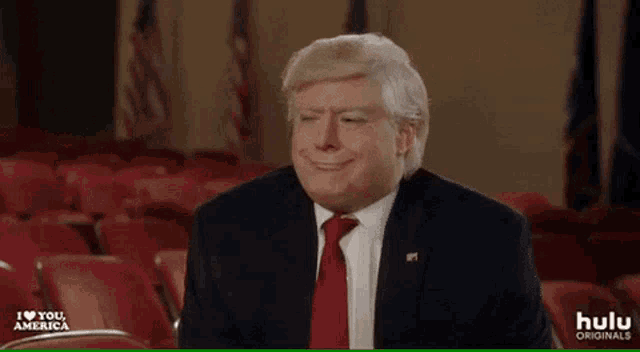 a man in a suit and tie is wearing a wig and smiling .