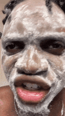 a man with a white mask on his face makes a funny face