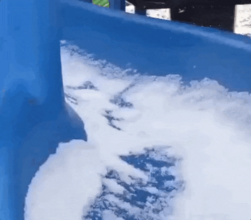 a blue water slide with a lot of foam on it .
