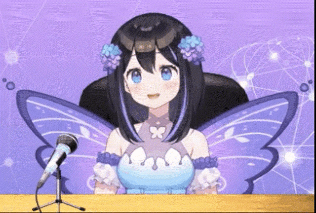 a girl with butterfly wings is sitting at a desk with a microphone
