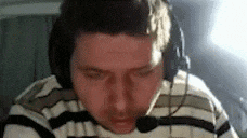 a man wearing headphones and a microphone is looking at the camera .