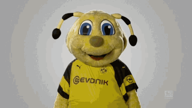 a mascot wearing a yellow and black jersey that says evonik on it