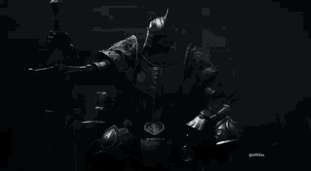 a man in armor is holding a sword in his hand