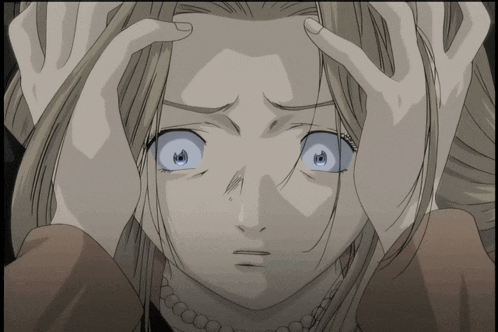 a close up of a woman 's face with her hands on her head