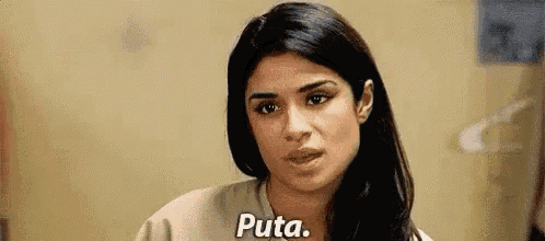 a woman is looking at the camera and says puta .
