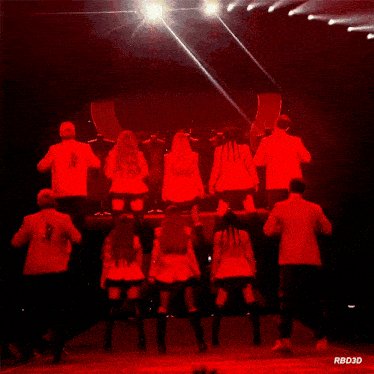 a group of people are dancing on a stage with the letters rbd3d on the bottom
