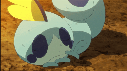 a cartoon character is laying on the ground with a yellow flower in its mouth