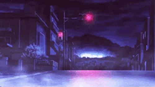 a city street at night with a red light and a purple sky .