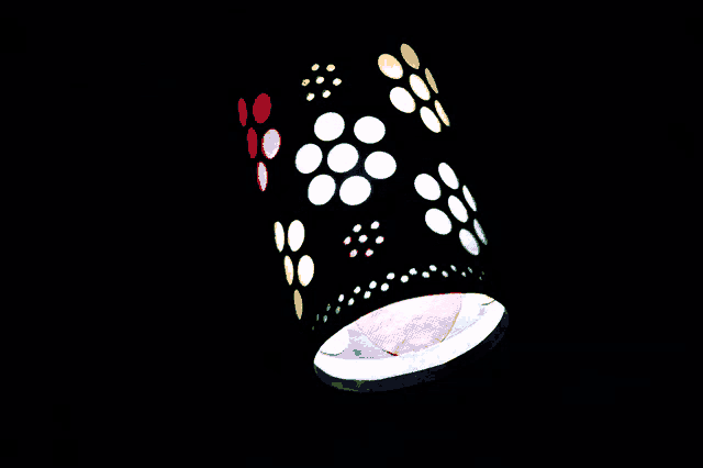 a cylindrical object with flowers and circles on it