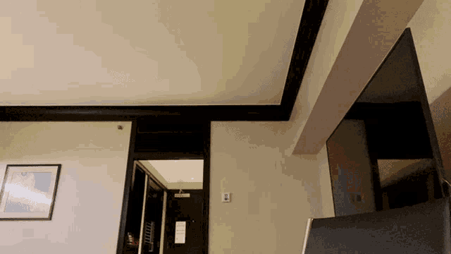 a hotel room with a picture on the wall that says ' a ' on it