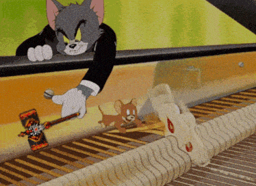 tom and jerry are playing a piano in a cartoon