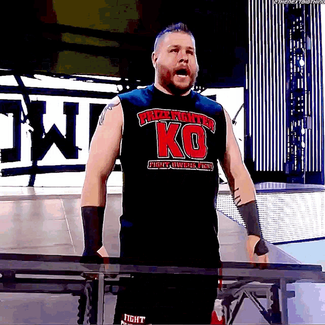 a wrestler wearing a black shirt that says ko